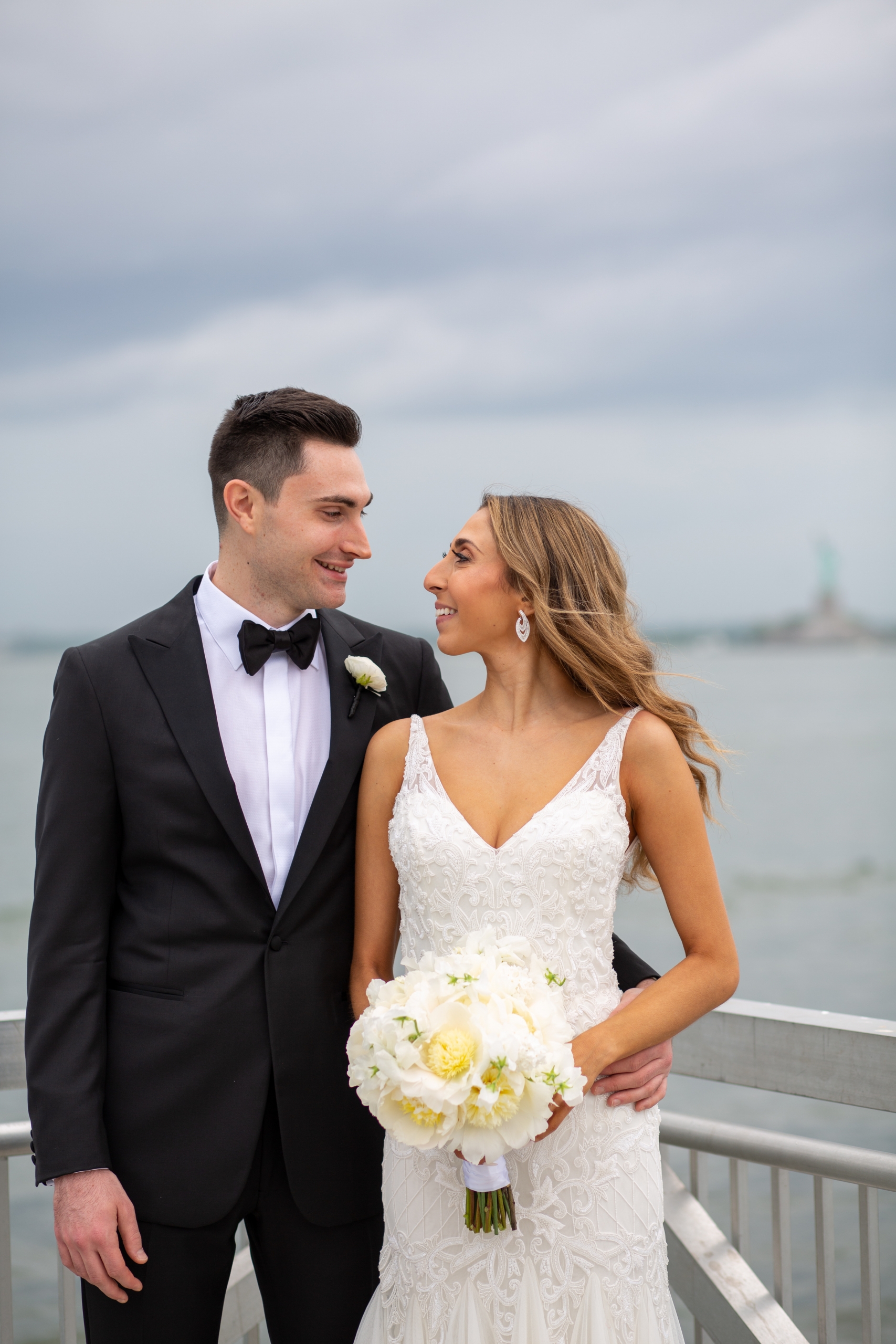 I’ve photographed many weddings at Liberty Warehouse over the years, and it never fails to inspire me. The light pours in through the tall arched windows, which helps to create dreamy, natural portraits, while the expansive waterfront promenade is perfect for a first look or magic hour photos. Whether it’s a heartfelt ceremony indoors or a lively dance floor beneath twinkling lights, every wedding here feels beautifully personal. Red Hook itself adds an extra layer of charm - offering cobblestone streets, eclectic local restaurants, bars and shops, and an authentic BK energy that makes the day feel even more special.